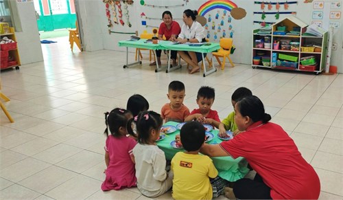 Các bé lớp mầm 1 học tạo hình  quấn dây trang trí viên kẹo